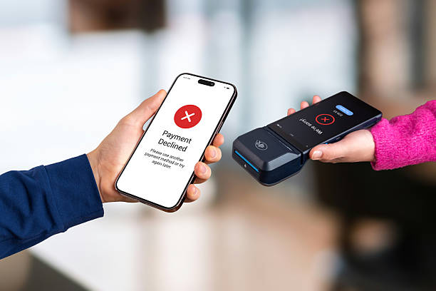 istock Mobile payment fails during NFC tap-to-pay interaction, showing red decline screens on both devices as customer attempts a contactless transaction at the POS terminal 2251437245