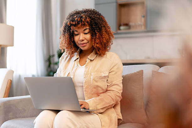 istock Woman working on laptop from home, telecommuting on a couch 2251437976