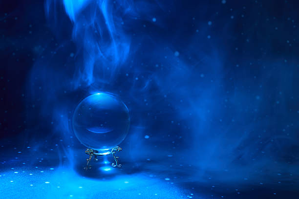 Mystical Blue Sphere. A crystal ball surrounded by blue mystical smoke creating an ethereal ambiance.