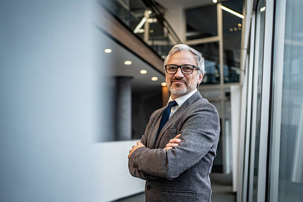 istock Mature businessman standing confidently in modern office building 2251439624