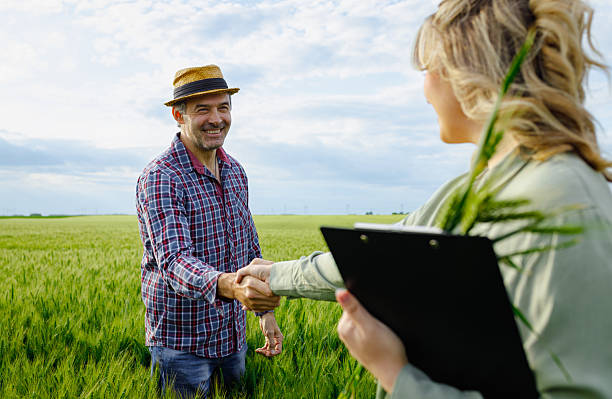 istock Two farmers in wheat field making agreement with handshake. 2251440756