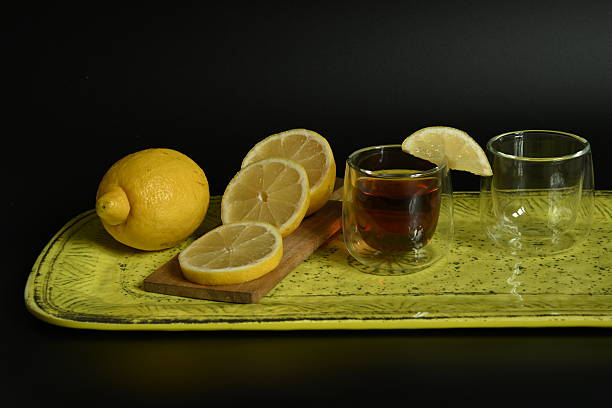 istock Vibrant Still Life: Tea and Lemon Slices on a Yellow Ceramic Tray 2251440908