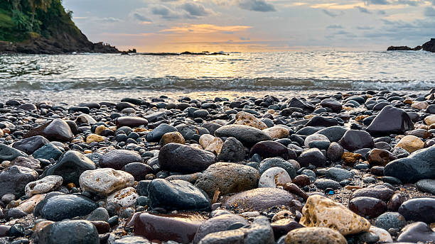 istock Low Angle View of Wet Beach Pebbles at Sunset 2251443007