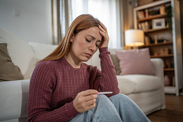 istock Woman feeling sad looking at negative pregnancy test 2251446774