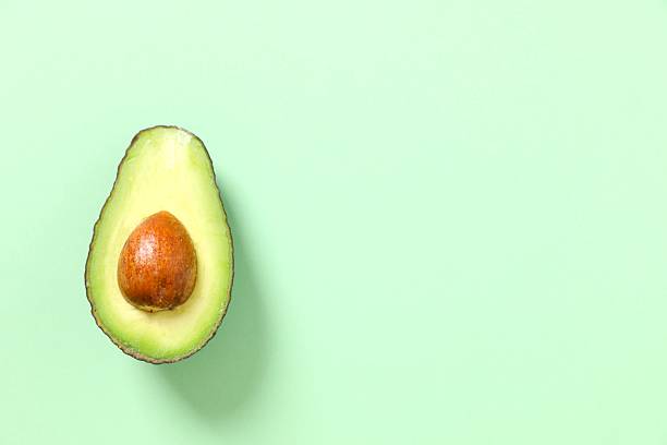 istock Green avocado on a colored background 2251451127