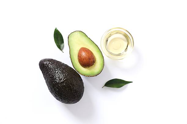 istock Green avocado with oil on white background 2251451189