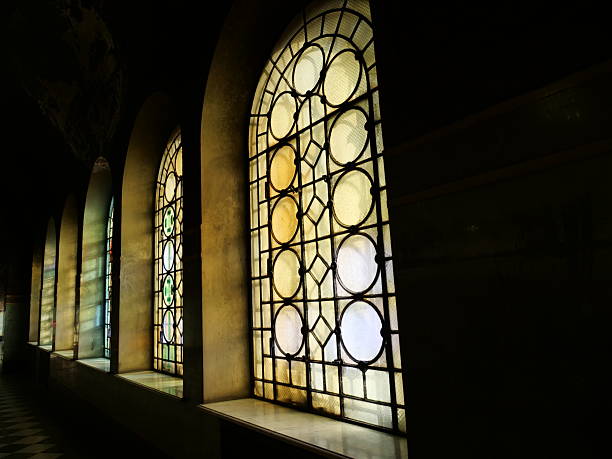 istock featuringarched geometric stained-glass windows. Natural light streams through thewindows, 2251452107