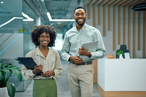 istock Diverse business professionals smiling in modern office environment 2251455190