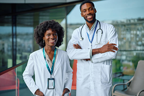 istock Two African American doctors standing smiling looking at camera 2251455231