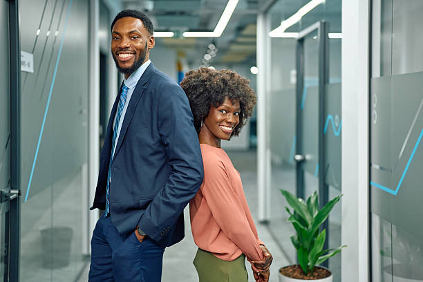 istock Professional business colleagues standing back to back in office 2251455432