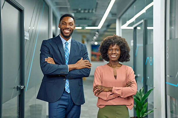 istock Smiling African American business colleagues posing in modern office 2251455433