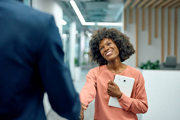 istock Executive woman shaking hands making business deal 2251455450