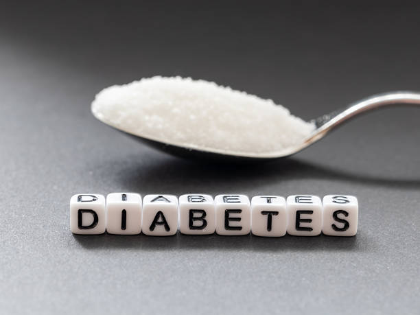 The name diabetes formed by white beads on a gray background on the side is sugar