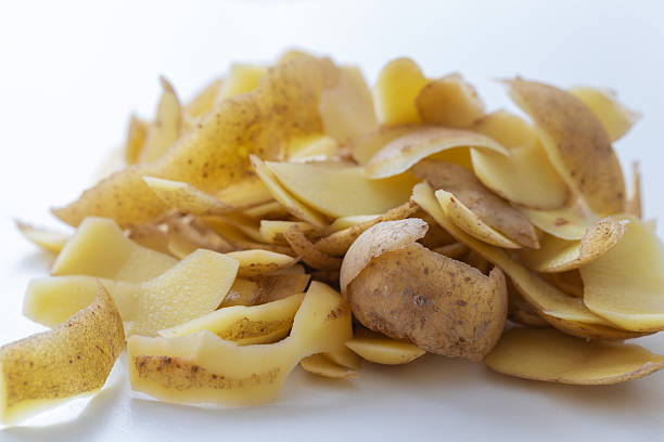 Potato peels crawling on a white napkin on the table.