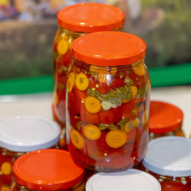 Stacks of Masson Jars Pickled Mix Carrots Peppers Herbs in Brine Food Preserving