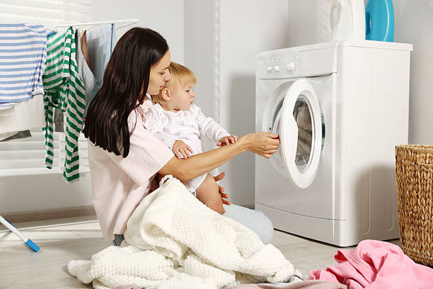 istock Mother with her little daughter doing laundry at home 2251462919