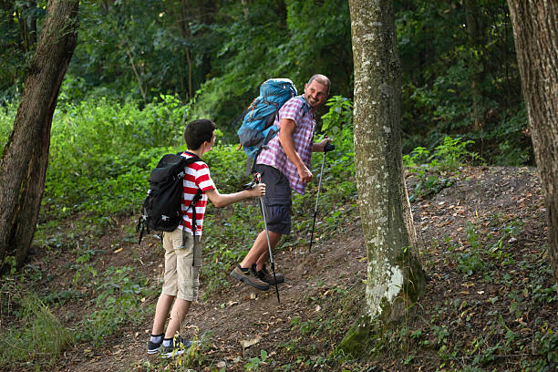 istock Father and son bonding on forest hike 2251462971