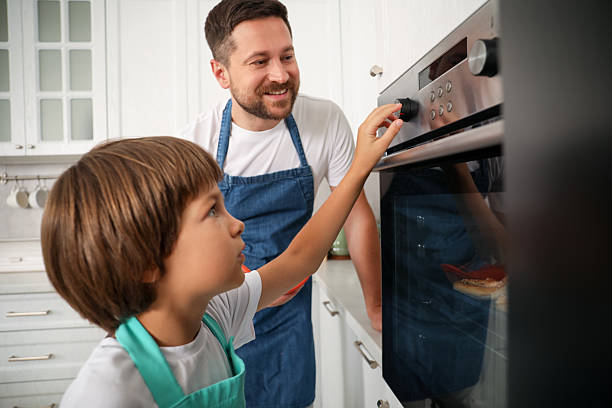 istock Father and son baking together in kitchen 2251463989