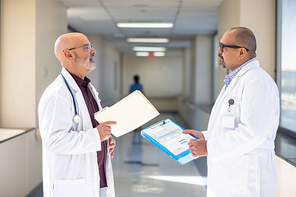 istock Two doctors discussing a patient file in the hospital hallway 2251465175