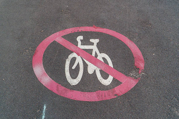 istock Weathered No Cycling Sign Painted on Asphalt Surface, Indicating Bicycle Restriction in a Specific Area. 2251466138