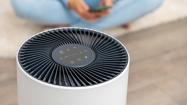 istock Modern air filter device with sleek design and control panel, enhancing indoor air quality in a cozy living space with copy space 2251467625