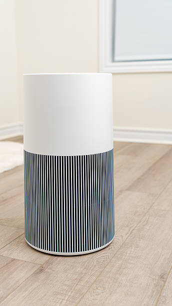 istock Modern air filter device with sleek design and striped texture, placed on wooden floor in bright room, enhancing indoor air quality and aesthetics 2251467675