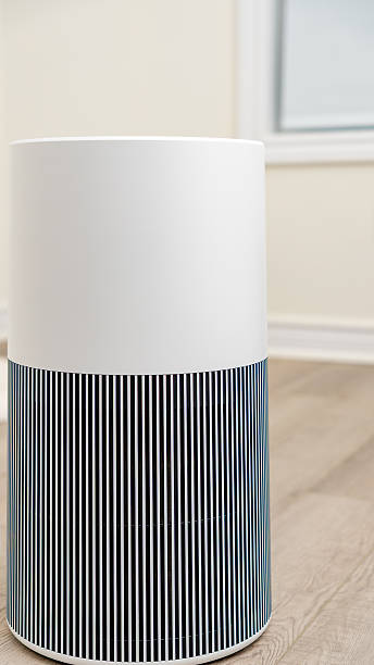 istock Modern air purifier with sleek design and vertical stripes, placed in a bright room, enhancing indoor air quality and promoting wellness 2251467676
