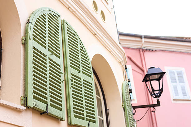 Building with green window shutters and lantern, closeup