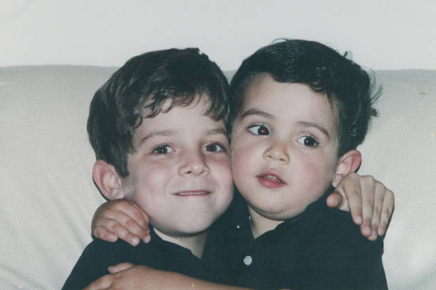 istock Image taken in 1980s: little male siblings embracing 2251469205