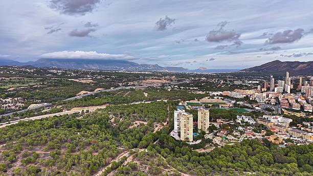 istock Aerial perspective showcasing urban sprawl blending seamlessly with lush greenery and waterways 2251471038