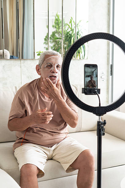 istock Senior man vlogging about applying a face mask 2251473022