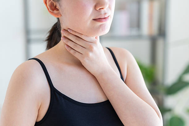 istock Young woman with a sore throat 2251473434