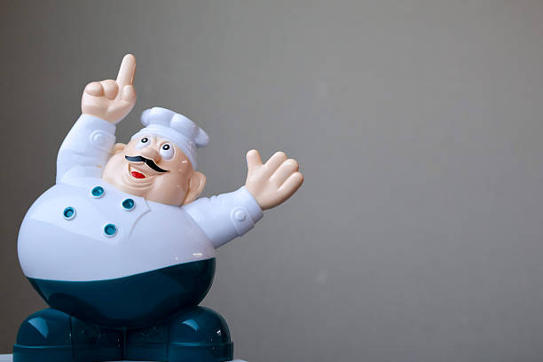Male chef take selfie with smartphone while working in a modern kitchen with his staff