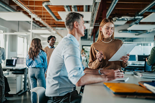 istock Coworkers discuss project details in modern office space in Berlin during work hours 2251475222