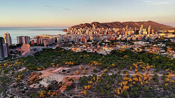 istock Beach sunrise landscape, Dawn unfolds over elevated coastal landscape with development along shore 2251476839