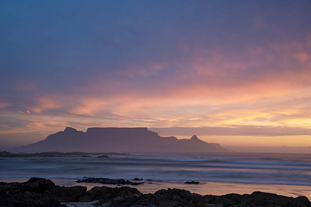 Landscape image of Table Mountain with beautiful clouds and sunset.