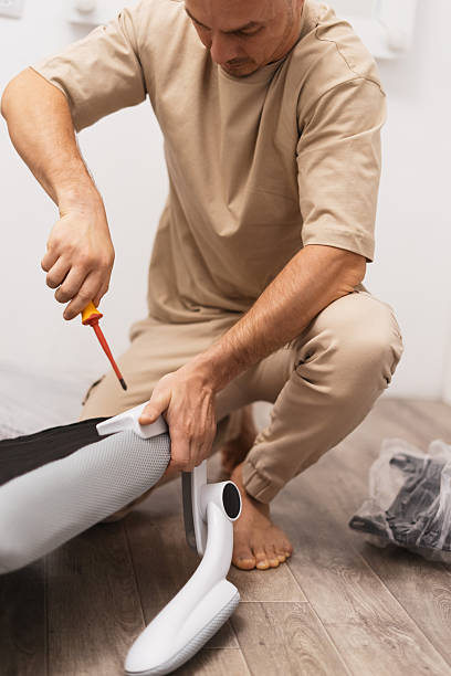 Man performs repair ergonomic office chair securing bolt screwdriver, ensuring comfort, structural support. Detailed view captures precise maintenance work essential long-lasting workspace equipment.