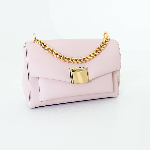 istock Light soft pink women's handbag on a white background. Stylish accessories and clothes 2251480647