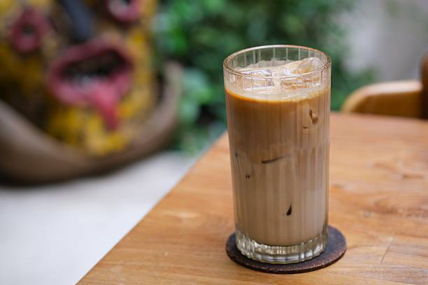 istock Iced Coffee in Tall Glass on Wooden Table 2251481878