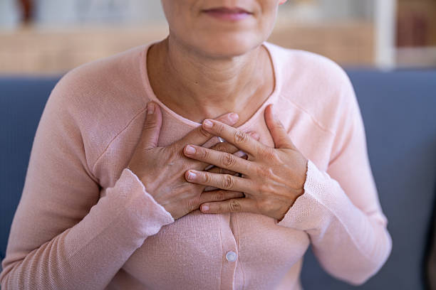 istock Woman feeling chest pain at home having a heart problem 2251482787