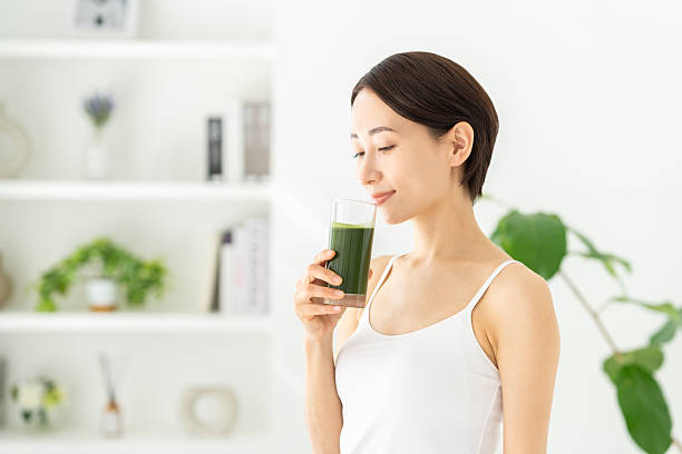 istock Middle-aged woman drinking green juice 2251484676