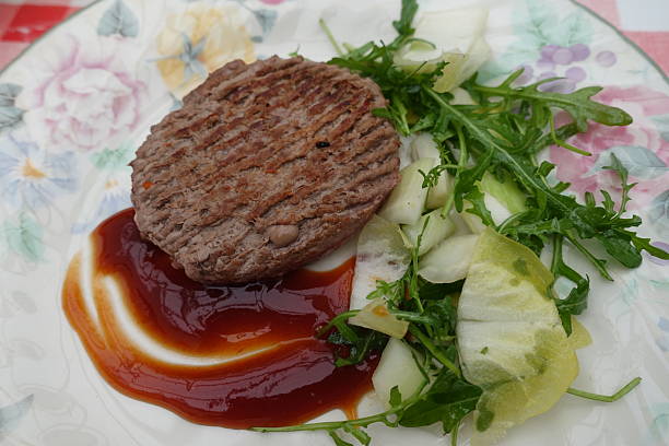 Browned minced beef, Charolais beef served with endives and dressed arugula salad