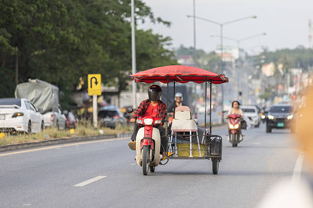 11 December 2025, Phuket Island - Thailand.Tricycles are the most practical form of transport on Phuket iIsland, especially for short distances, errands, and commuting, and helmet use is often inconsistent despite safety regulations.