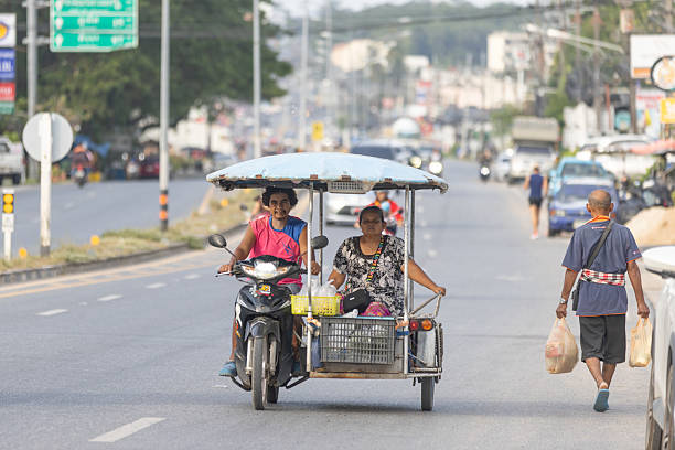 11 December 2025, Phuket Island - Thailand.Tricycles are the most practical form of transport on Phuket iIsland, especially for short distances, errands, and commuting, and helmet use is often inconsistent despite safety regulations.