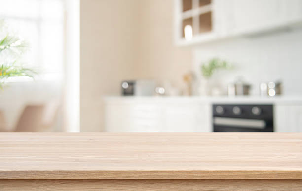 istock Wooden table top for product display with deeply blurred kitchen corner interior background 2251497415