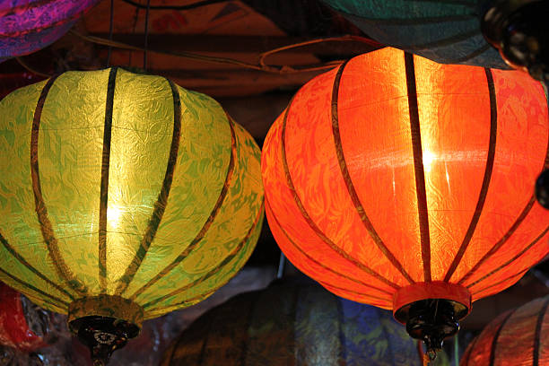 CU low angle green and orange glowing silk lanterns