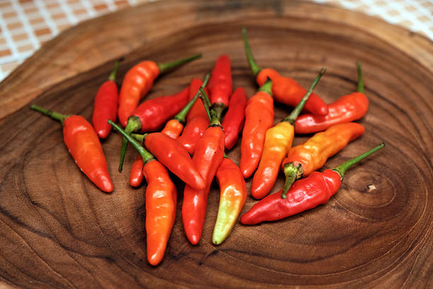 istock Fresh Red Cayenne pepper on a wooden cutting board 2251500970