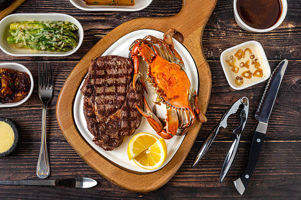 istock Tenderloin steak served with whole crab and lemon wedge 2251501304