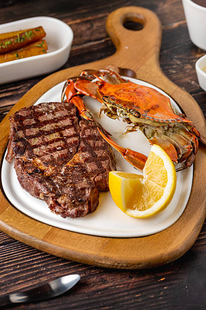 istock Tenderloin steak served with whole crab and lemon wedge 2251501316
