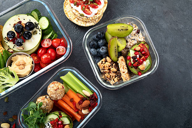 istock Bbox containing fresh fruits, vegetables, sandwiches, and nuts. 2251501584